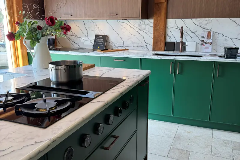 A BORA cooktop with a gas wok burner and induction, set into a marble island in our showroom's BORA room