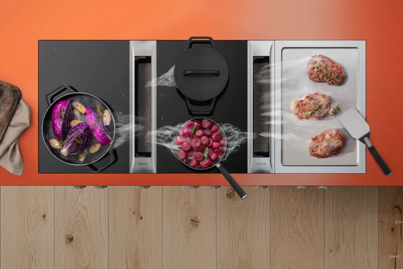 BORA cooktops from above, drawing steam down from the pans