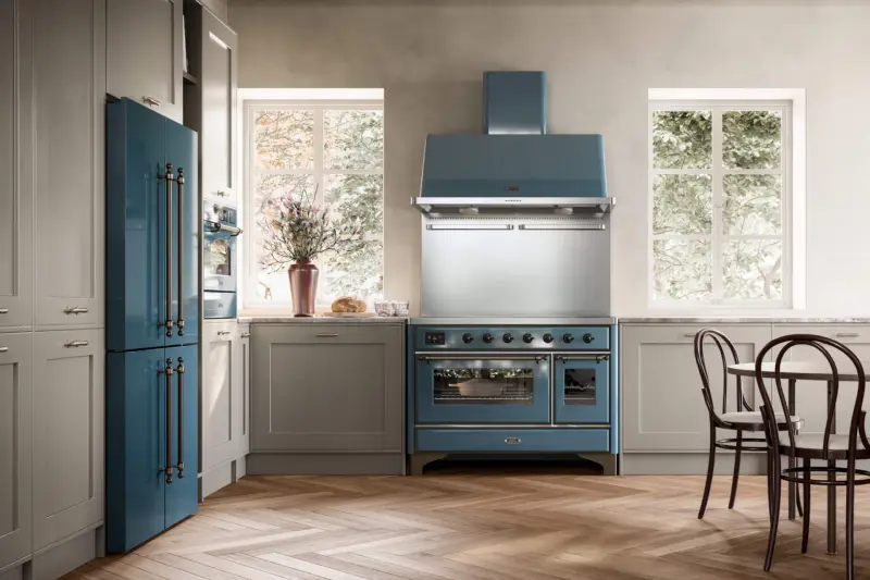 A blue ILVE Majestic range cooker with a matching hood