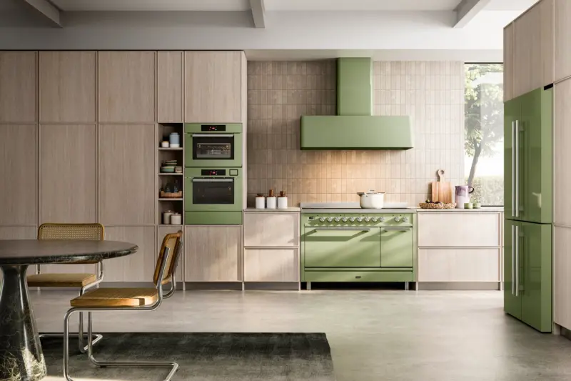 A sage green ILVE range cooker in a modern oak kitchen