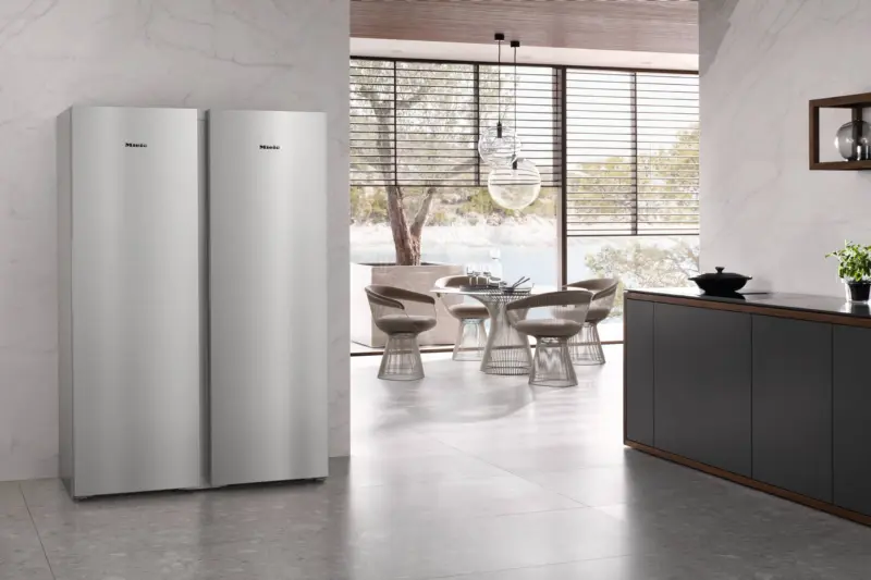 Two Miele fridge freezers in a stone and marble kitchen