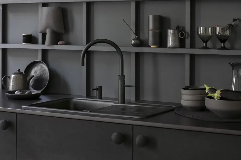 A black Quooker Fusion Round tap over a black sink