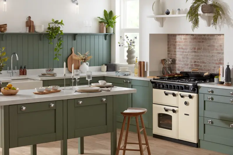 A cream Rangemaster Classic range cooker in a sage green kitchen