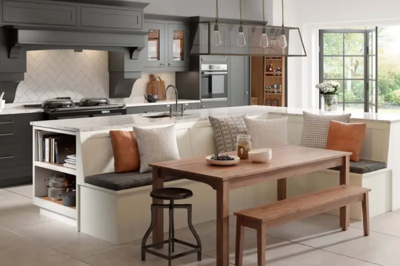 A Caledonia Stroma kitchen in Blizzard White and Fired Charcoal, with a built-in dining bench