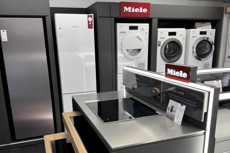 The Miele display in our Hawkhurst showroom, with fridge freezers, washing machines, tumble dryers and an induction hob